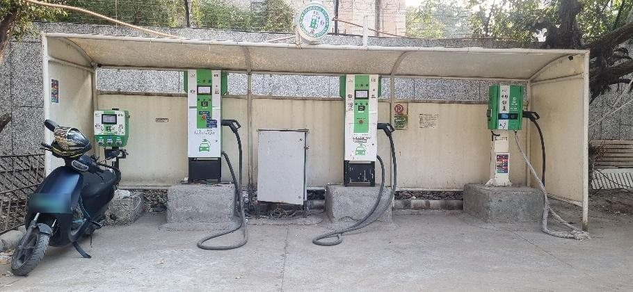 Row of EVIT chargers under a shelter at a public charging station in Delhi